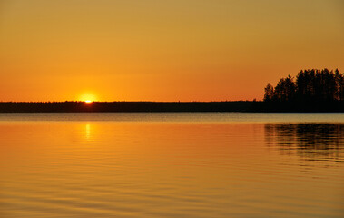 Fototapeta na wymiar Sunset over wild Lake Haikola