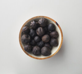 Top view shot of dried lime on white background.
loomi, limoo amani, black lime, persian lime