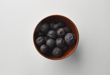 Top view shot of dried lime on white background.
loomi, limoo amani, black lime, persian lime