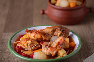 Stewed Chicken with vegetables on wooden table