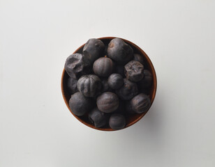 Top view shot of dried lime on white background.
loomi, limoo amani, black lime, persian lime