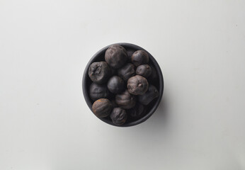 Top view shot of dried lime on white background.
loomi, limoo amani, black lime, persian lime