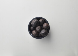 Top view shot of dried lime on white background.
loomi, limoo amani, black lime, persian lime