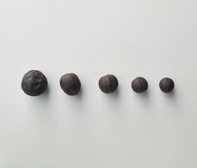 Top view shot of dried lime on white background.
loomi, limoo amani, black lime, persian lime