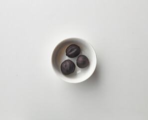 Top view shot of dried lime on white background.
loomi, limoo amani, black lime, persian lime
