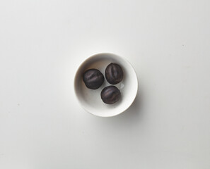 Top view shot of dried lime on white background.
loomi, limoo amani, black lime, persian lime