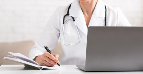 Sick patient complains to doctor to conference call, using laptop. Woman in white coat makes notes in notebook
