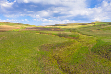 Fototapeta na wymiar Brook valley in a rural landscape