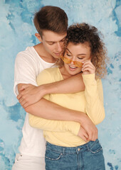 Happy young couple posing on blue background