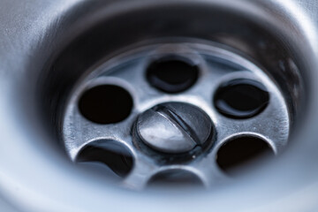 macro close-up if water flowing through a drain in a sink. High quality photo