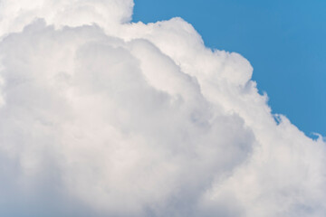 A large entrance cloud hovering in the blue sky in midsummer.