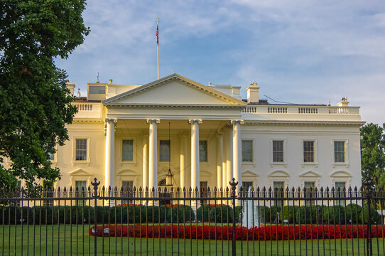 Sunrise light on the front entrance of White House, presidential residence and executive office of the President of the United States of America in Washington DC.