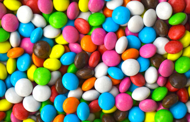 Fototapeta na wymiar Multicolored candy beans background. Greeting concept for Christmas, Easter or birthday. Unhealthy food. Banner