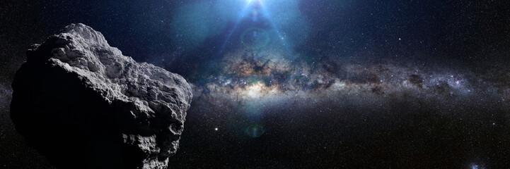 Fototapeta na wymiar asteroid in deep space lit by the Sun