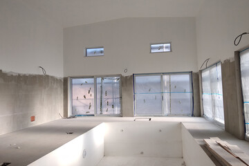 Fototapeta na wymiar Interior of a house with big swimmig pool under renovation works.