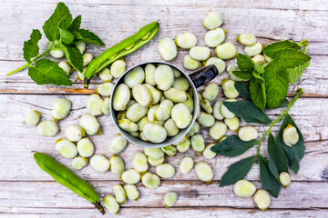 Freshly shelled broad beans in a mug.