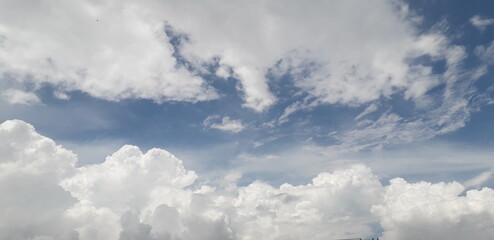 Naklejka na ściany i meble Clouds in the blue sky date-07/07/20 location-haryana, india