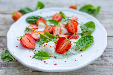 A healthy and delicious salad made from fresh strawberries and mozzarella.
