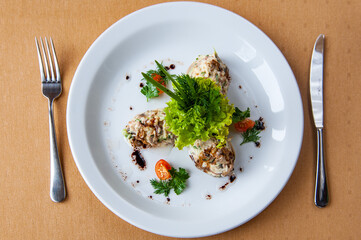 Restaurant food, fish paste served on a white plate on a side dish salad with tomato