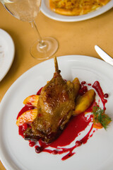 duck leg with apples in cranberry sauce