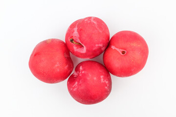 Red plums on white background