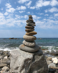 stone pyramid by the ocean. stone tower by the water