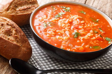 Tomato soup with rice and seasonal vegetables close-up in a bowl on the table. horizontal