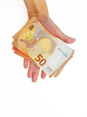 The woman's hand stretches the paper money of the euro against a white background. Bribe. Loan repayment. Mortgage. Duty. Salary. Installment.