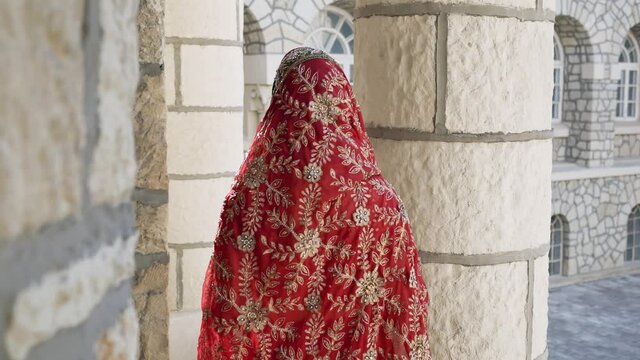 Indian Saree. View from the back of woman in red, colorful, sensual, wedding and very feminine outfit - Indian sari walks along old streets in India. Traditional national clothing of Indian women