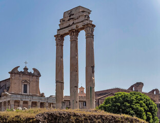 Fototapeta na wymiar Rome Italy, three columns of the Dioscouroi temple and Santa Franchesca church partial view in the Roman forum