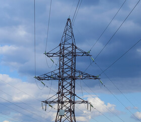 high voltage electric line against a cloudy autumn sky
