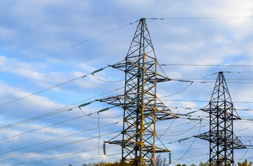 high voltage electric line against a cloudy autumn sky