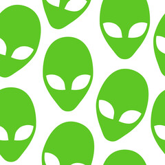 Green alien heads seamless pattern. Flat simple alien heads symbols repetitive vector illustration. 