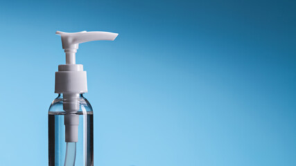 Hand hygiene disinfectants. Spray bottle on blue background, copy space.	