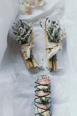 Overhead shot of beautifully arrange smudge sticks on white wrapping paper