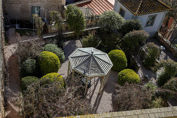 Top view of beautiful garden with a gazebo and bushes. Rest area at home