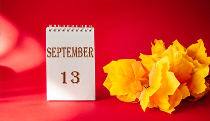 Calendar with the text October 13 on a red background and with a maple leaf