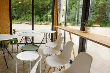 Coffee shop interior with empty chairs and tables. A new reality during the coronavirus pandemic.