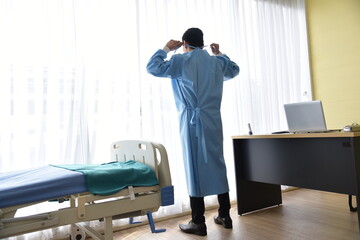 An Asian male doctor is wearing surgical blue gown in the office Hospital /Preparation for Surgery  operation