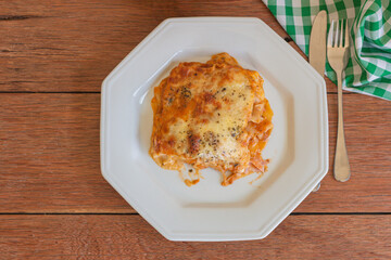 Traditional italian lasagna with cheese. On a wooden background.