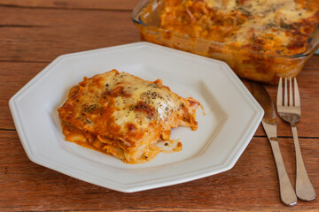 Traditional italian lasagna with cheese. On a wooden background.