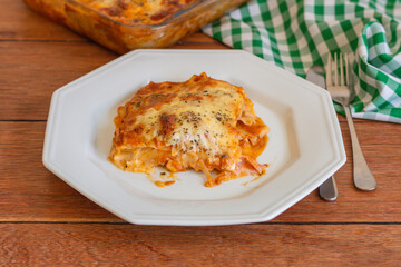Traditional italian lasagna with cheese. On a wooden background.