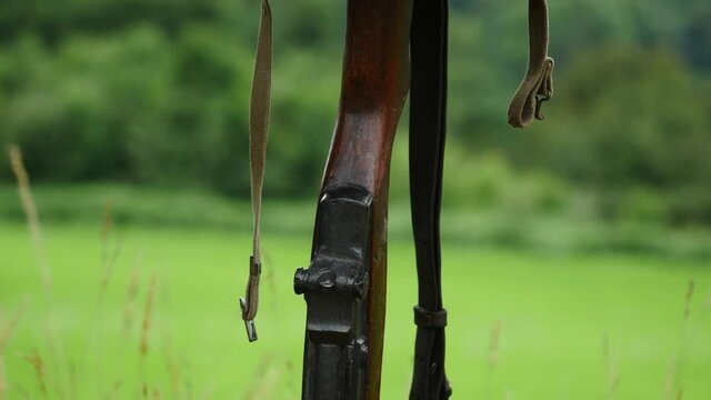 Memorial battlefield cross. Symbol of a fallen US soldier. M1 rifle with helmet.