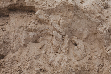 background image, a mountain of sand. sand with traces of rain. raindrops on dry sand
