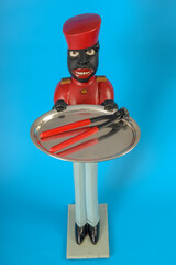 Statue of a black servant with a tongs on the tray