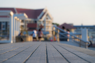 Fototapeta premium Close up view and copy space of concrete floor. The field was divided into equal in the multipurpose yard of public places. Blurry building background during the evening.