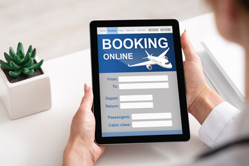 Businesswoman With Digital Tablet Booking Flight Online In Office, Cropped