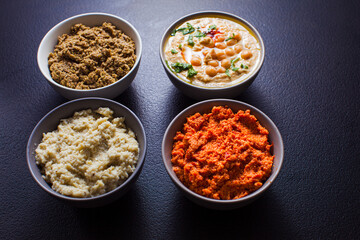Bowls with delicious hummus and veggie spreads