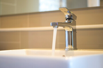 Water flows out of the tap on the sink.