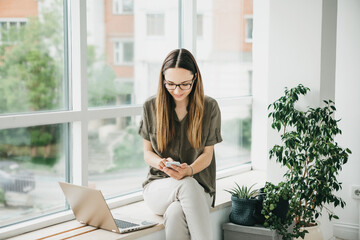 Girl with laptop and cellphone.